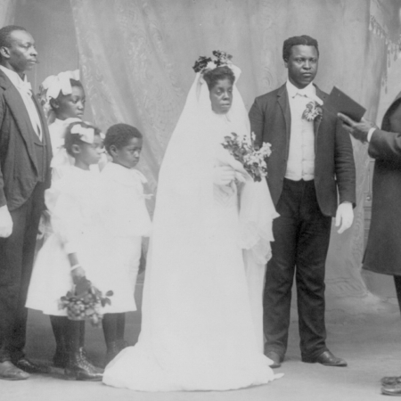 Photo of 1908 black bridal party before minister