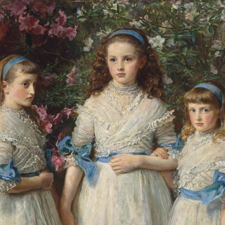 Three girls in white dresses with blue sashes